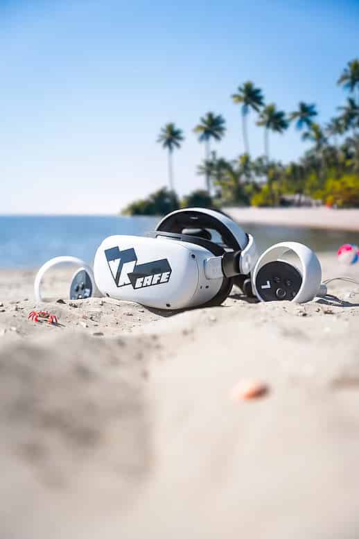 A Virtual Reality headset with VRcafe Haarlem logo laying on a beach