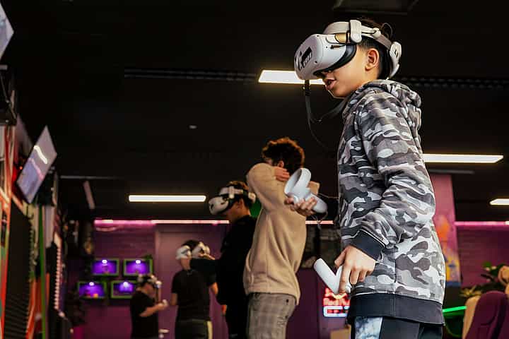 A group of school children playing VR games together