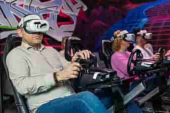 3 people racing on a Formula 1 simulator
