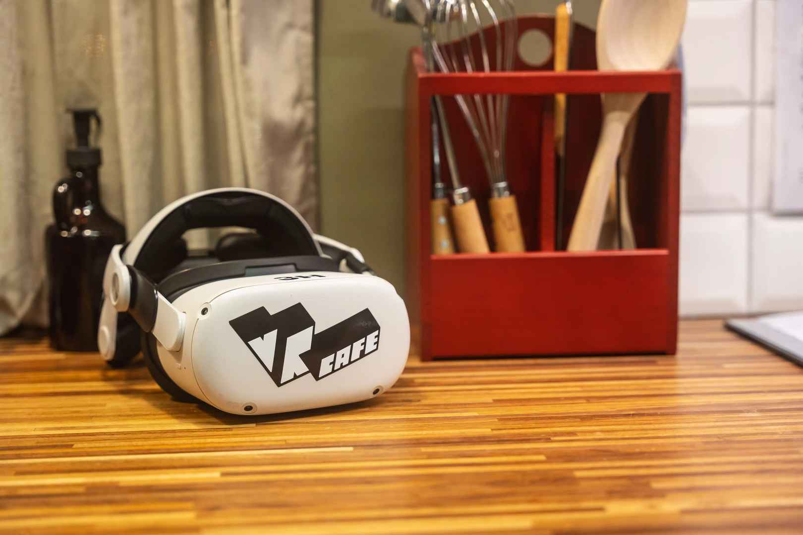 Meta quest 2 headset rent from VRcafe Haarlem VR@HOME service laying on a wooden kitchen top